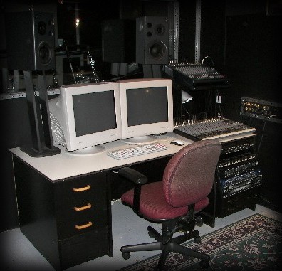 Custom studio workstation with two CRT monitors, a mixer and a small rack of sound gear