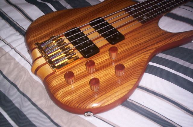 Striped hardwood bass with wooden knobs, angled view