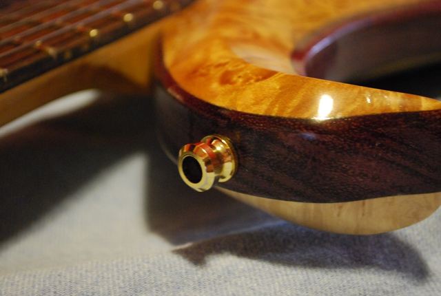 Burl body edge with gold output jack