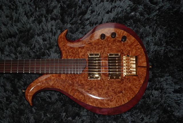 Burl-top guitar body with purple binding