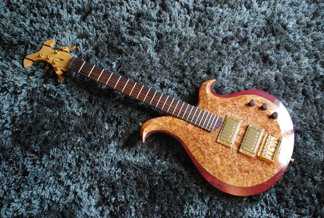 Burl-top guitar with gold hardware, full view