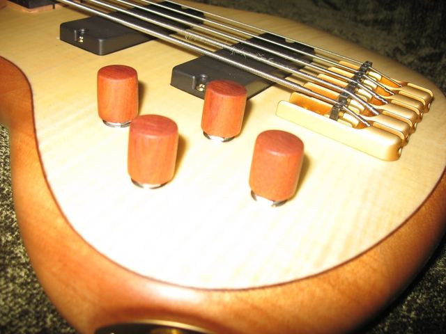 Wooden knobs installed on a maple bass