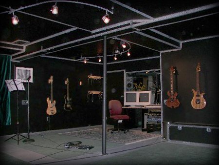 Main studio room with track lighting and instruments on the walls