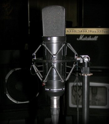 Studio condenser microphone with a Marshall amp behind it